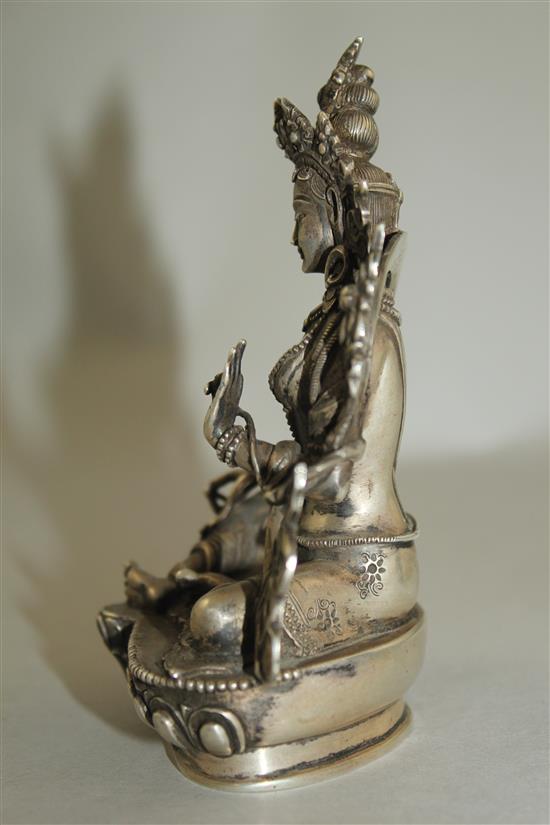 An unusual Tibetan silver seated figure of Green Tara, possibly 19th century, 11.7cm